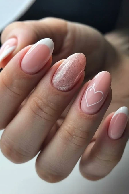 Elegant pink and white nail art with heart design and shimmer accent, perfect for stylish and feminine Valentine's manicure looks.