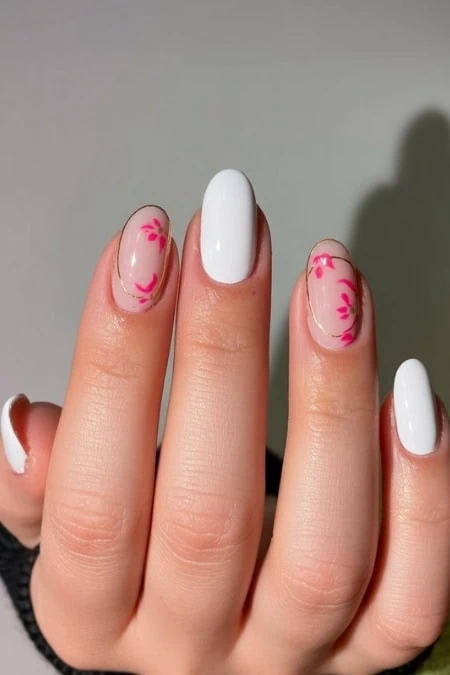 Elegant white and floral nail art design featuring pink accents, perfect for a chic and modern manicure look, ideal for fashion-forward individuals seeking stylish nail inspiration.