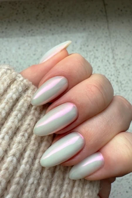 Elegant pearlescent almond-shaped nail design with a soft iridescent sheen, perfect for a sophisticated, trendy look and ideal for custom nail art or luxurious manicure styles.