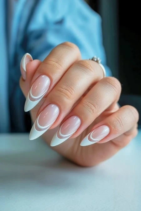 Stunning manicured nails with elegant white and clear swirl design for a chic, modern look, showcasing professional nail art and beauty care.