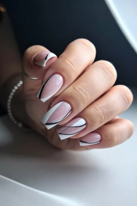 Elegant modern French manicure with black geometric accent lines on natural nails, stylish and perfect for beauty and nail art enthusiasts.