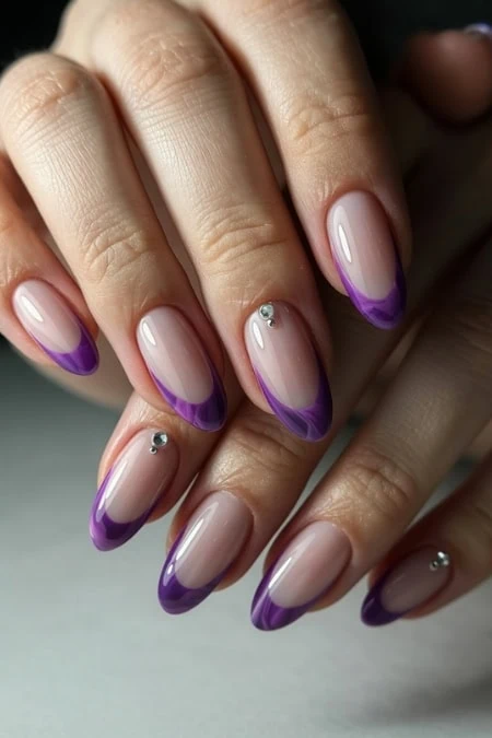 Elegant purple French manicure with rhinestone accents on natural nails, perfect for beauty and nail art inspiration.