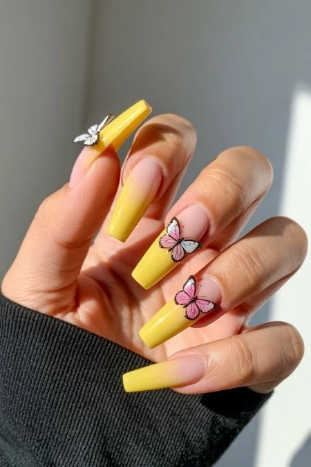 Elegant butterfly nail art with pastel purple and peach tones on almond-shaped nails, featuring detailed butterfly designs for a trendy and delicate look.