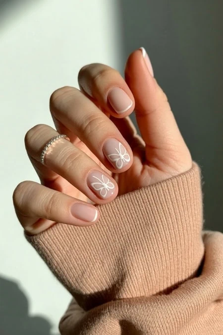 Elegant butterfly nail art with pastel purple and peach tones on almond-shaped nails, featuring detailed butterfly designs for a trendy and delicate look.