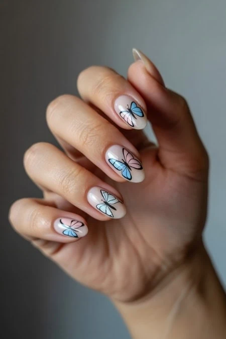Colorful butterfly nail art with pastel shades on well-manicured nails, perfect for spring or summer beauty trends. Professional nail design highlighting creative, delicate, and trendy nail art styling.