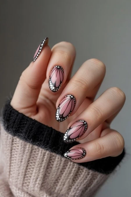 Delicate butterfly nail art with pink, black, and white accents, perfect for a chic and creative manicure. Beautiful, detailed nail design showcasing expert artistry and modern trends.