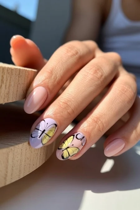 Colorful butterfly nail art with pastel purple and yellow designs, perfect for stylish and trendy manicure ideas.