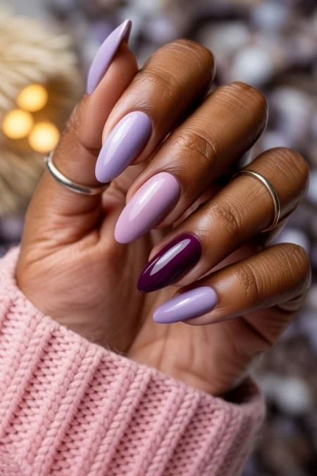 Elegant lavender and deep purple gel nail polish manicure, perfect for spring or summer, showcasing professional nail art and beautiful hand skincare.