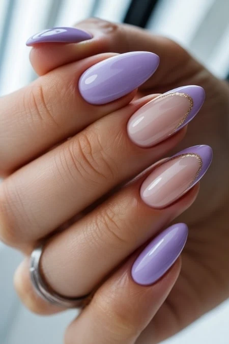 Elegant lavender and nude almond-shaped nail art with gold accents, perfect for a sophisticated beauty look and ideal for women seeking stunning, trendy manicure ideas.