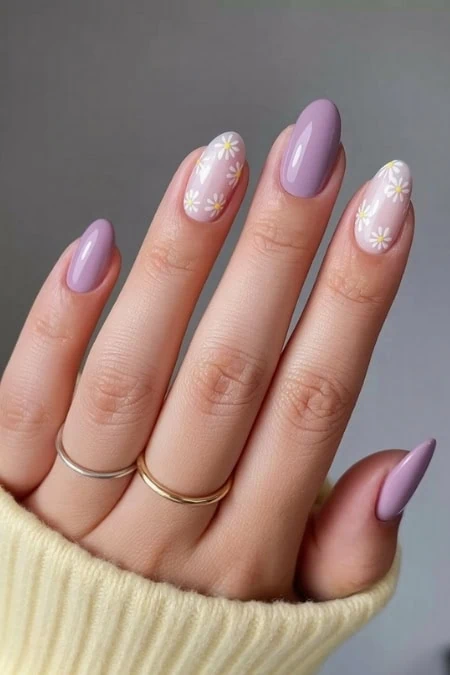Pastel purple and floral nail art with daisy accents on acrylic nails, cosmetology, and manicures for a fresh, feminine, and trendy look.