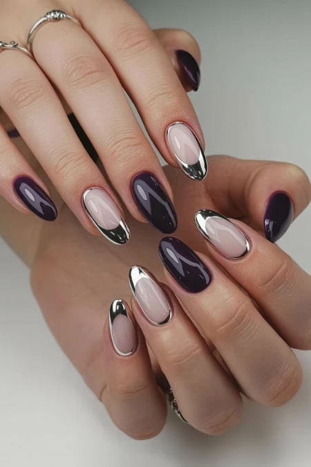 Elegant black and silver manicure with glossy finishes and gel nail art designs. Perfect for stylish, modern nail art enthusiasts.