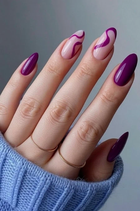 Vibrant purple and pink marble nail art on manicured nails, showcasing trendy and stylish manicure. Perfect for beauty and nail art enthusiasts seeking modern nail design inspiration.