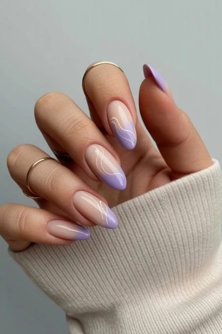 1. Elegant pastel lavender ombre nail art with white accents on natural nails, ideal for trendy beauty and manicure styles.