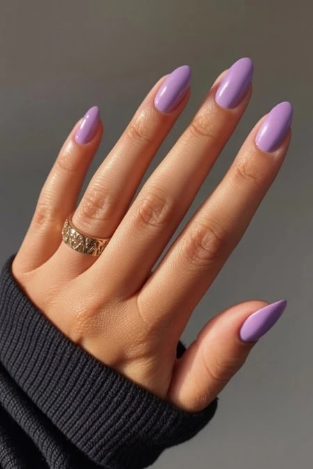 Violet pastel nail polish on manicured hand with gold ring, stylish and trendy nail art, perfect for beauty and self-care, close-up of well-groomed nails.