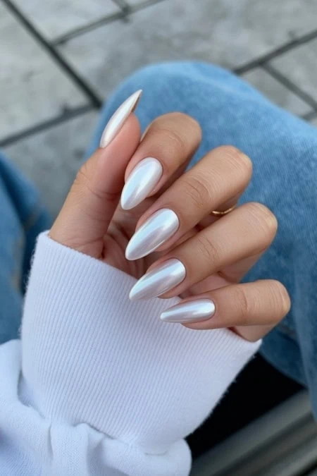 Elegant white gel manicured nails with a glossy finish on a woman's hand, showcasing perfect nail care and skincare beauty trends.