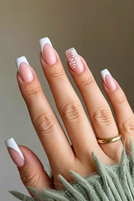 Elegant French manicure with daisy nail art on natural nails, perfect for beauty and nail art enthusiasts.