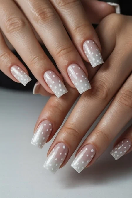 Elegant white polka dot nail art on French manicured nails, perfect for a chic and stylish look, ideal for beauty, nail art, and manicure inspiration.