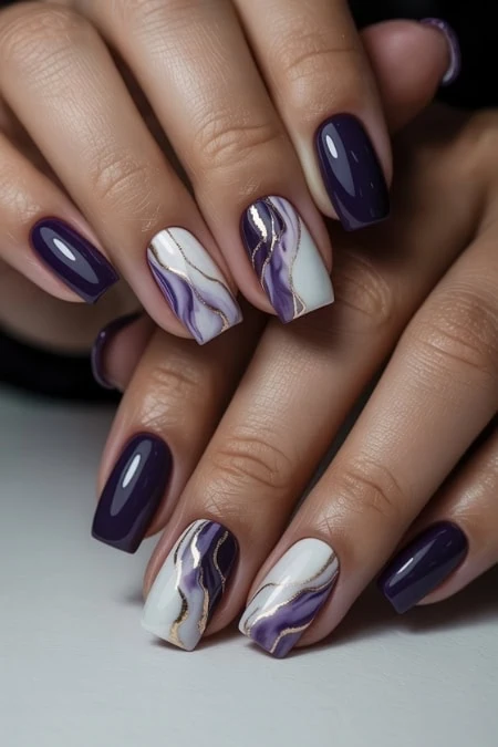 Elegant purple and white marble nail art with gold accents, perfect for beauty and manicure enthusiasts. High-quality gel polish design showcasing trendy nail art for 2023.