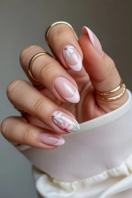 Delicate floral nail art with pink and white designs on well-manicured nails, showcasing elegant and trendy manicure ideas for women.