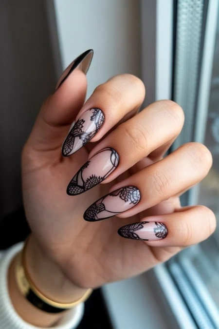 Elegant black lace floral nail art design on manicured nails, showcasing intricate patterns and a stylish manicure trend for beauty and nail art enthusiasts.