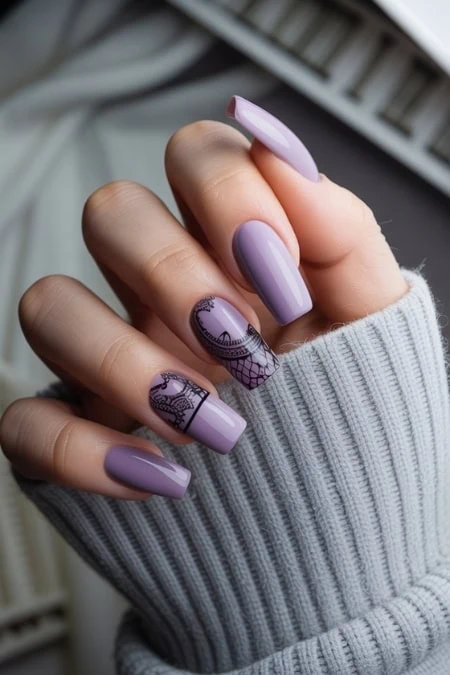 Elegant lavender nail polish with black lace design on manicure, showcasing trendy and stylish nail art for beauty and fashion enthusiasts.