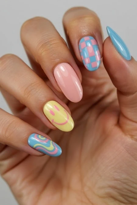 Colorful pastel nail art with smiley face and geometric patterns, perfect for summer or spring. Stylish and creative nail designs on well-manicured nails showcasing trendy nail art ideas.