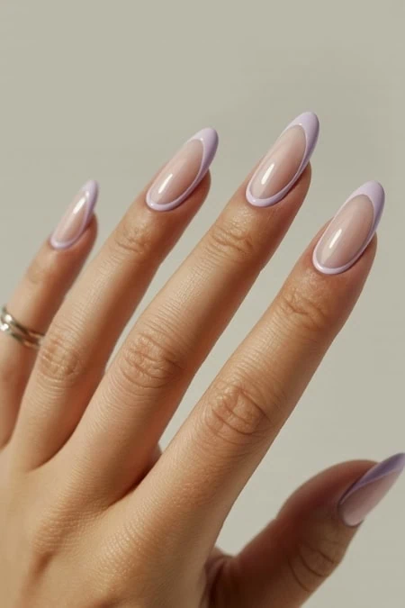 Elegant pastel purple French manicure with glossy finish ,perfect for beauty inspiration.