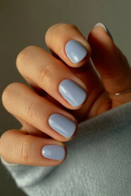 Bright pastel blue manicure with glossy finish, perfect for a sophisticated and trendy nail look. Professional nail art showcasing flawless, well-groomed nails for beauty and self-care enthusiasts.