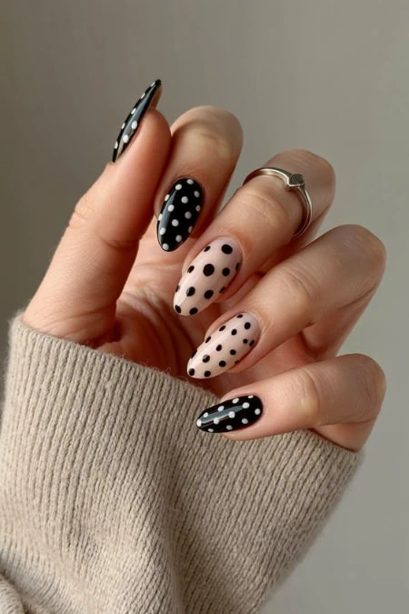 Black and beige polka dot manicure with stylish nails, trendy nail art design, perfect for beauty and fashion enthusiasts, showcasing creative nail painting techniques.