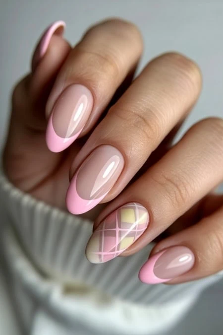 Elegant pink French manicure with plaid accent nail, perfect for beauty and nail art enthusiasts.