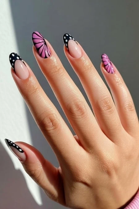 Bright pink and black butterfly manicure with polka dot accents for beauty lovers.