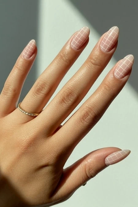 Short and simple, but informative and keyword-rich ALT: Elegant manicure with nude nail polish featuring white grid design, perfect for beauty, nail art, and fashion enthusiasts.