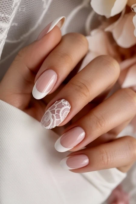 Elegant French manicure with intricate laces design on natural nails, perfect for bridal or special occasion beauty and nail care.