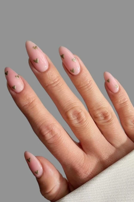 Bright pink French manicure with gold heart nail art, elegant and trendy nail design, perfect for special occasions and everyday wear.