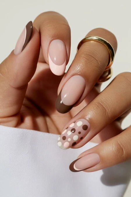 Beautiful modern nude and polka dot manicure with brown, beige, and pink accents showcasing stylish nail art, perfect for beauty and self-care enthusiasts.