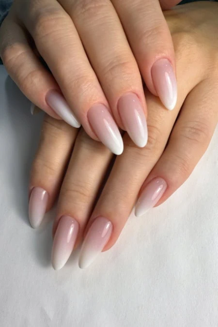 Elegant French manicure with glossy finish on natural nails, showcasing flawless nail care and beauty. Perfect for a sophisticated and polished look, ideal for any occasion.