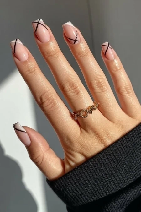 Elegant geometric nail art with minimalist black lines on square nails, perfect for contemporary style and beauty enhancement.