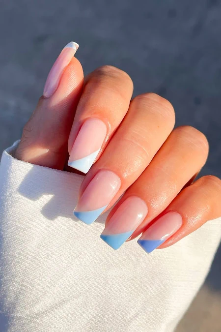 French manicure with blue tips on natural square nails, highlighting trendy nail art, perfect for beauty and fashion blogs.