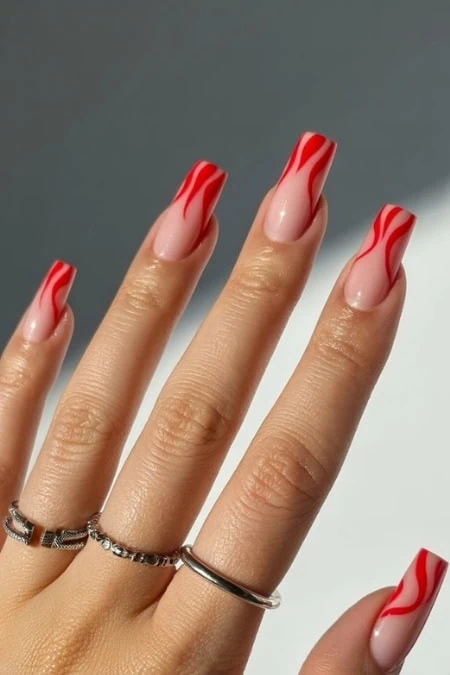 Elegant red nail design on well-manicured square nails, showcasing trendy and stylish nail art suitable for beauty and fashion enthusiasts.