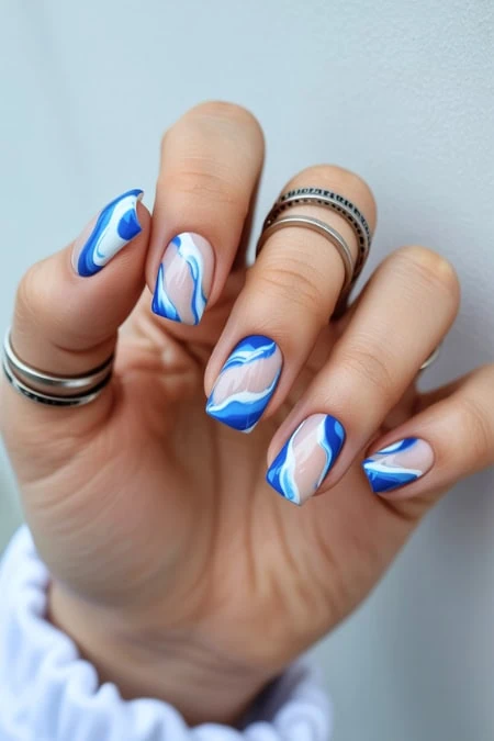 Beautiful hand showcasing intricate blue and white marble square nails design for a stylish and modern look. Perfect for beauty, manicure, and nail art enthusiasts.