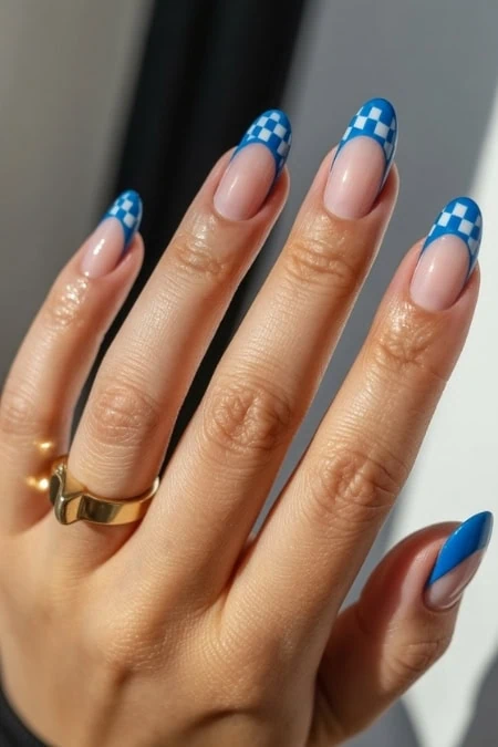 Stylish blue and nude checkered nail design on manicured fingers, highlighting trendy and creative nail art suitable for beauty, fashion, and self-care inspiration.