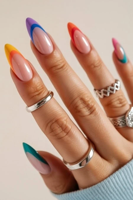 Vibrant multicolor nail design featuring bold, colorful tips on well-manicured nails, showcasing creative and trendy nail art perfect for fashion-forward individuals.