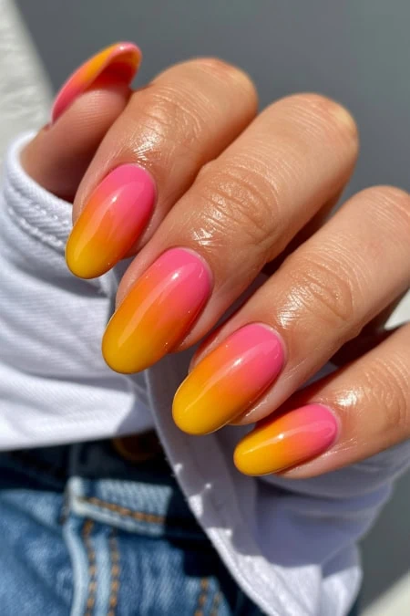 Beautiful gradient nail design with pink and yellow shades, perfect for summer and spring fashion. Showcasing vibrant, trendy, and eye-catching nail art for a fresh, stylish look.