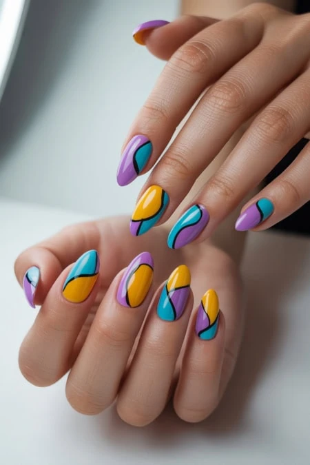 Vibrant, multicolored nail art with abstract patterns featuring purple, yellow, blue, and black accents, showcasing creative and trendy manicure styles.