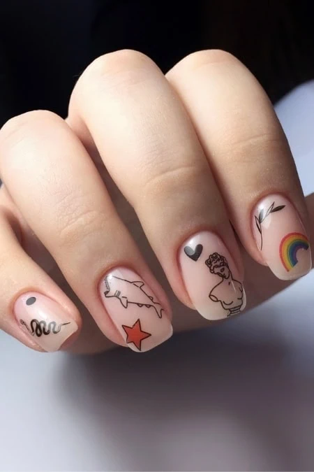 Vibrant nail art featuring various designs including a rainbow, star, heart, and abstract patterns on well-manicured nails, showcasing creative and trendy nail decoration ideas.