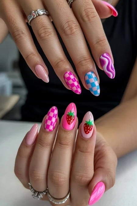 Vibrant nail art featuring pink, blue, and purple checkered patterns along with strawberry motifs, perfect for fashion-forward and trendy nail enthusiasts.