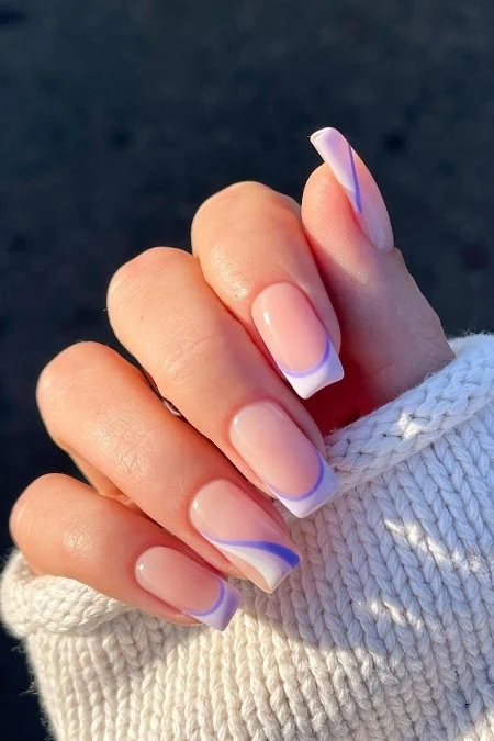 Elegant French manicure with purple accents.