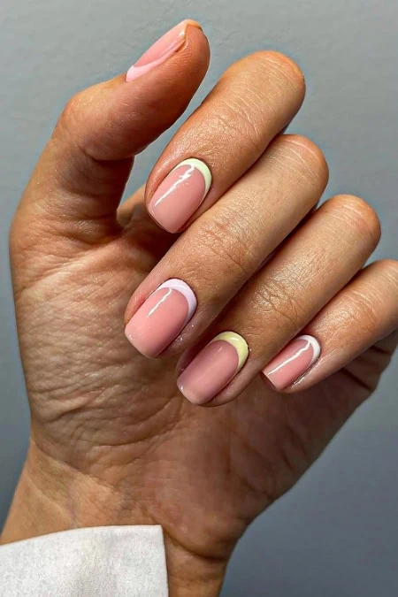 Beautiful French manicure with natural pink base and white tips, showcasing nail art and short square nails.