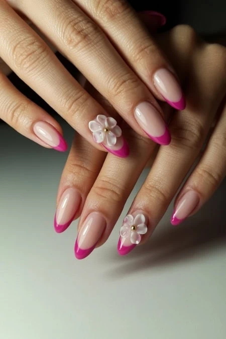 Elegant pink French manicure featuring a floral accent on the ring fingers, showcasing well-groomed nails with a glossy finish and delicate 3D flower embellishments.
