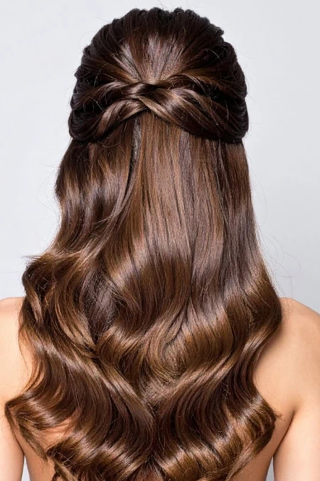 Beautiful long wavy hair styled with a braided crown, showcasing healthy, shiny, and voluminous hair perfect for a natural, elegant look.